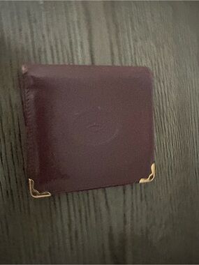 Cartier burgundy leather card case with gold corner detail